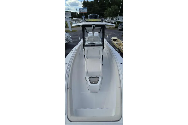 Slide: The Image of 2024 Sea Hunt Gamefish 27 Coffin Box boat interior, showcasing seating and helm. - 10
