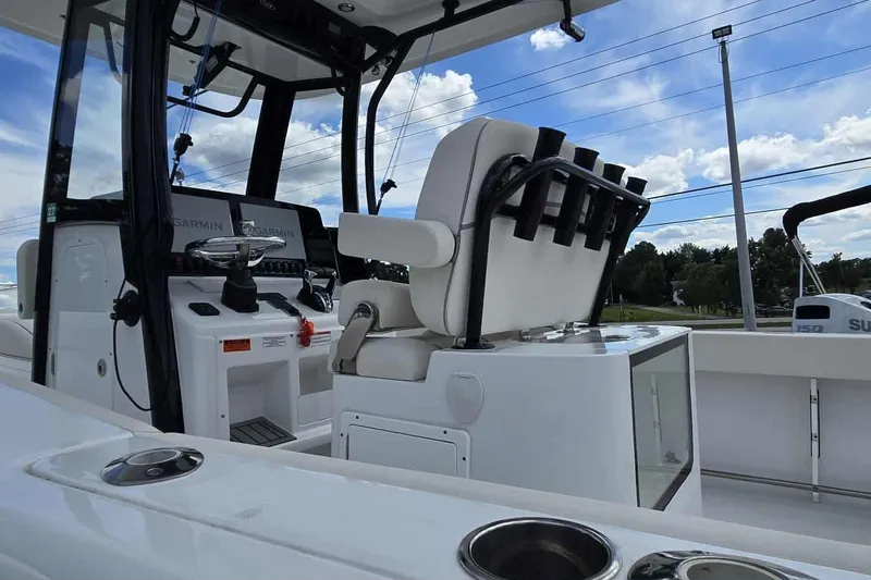 Slide: The Image of 2024 Sea Hunt Gamefish 27 Coffin Box boat interior with helm and seating. - 11