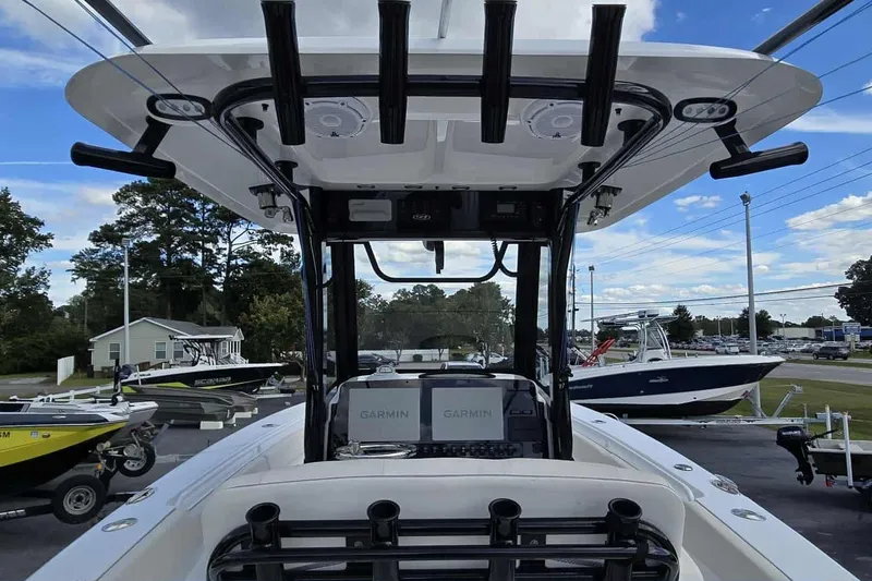 Slide: The Image of 2024 Sea Hunt Gamefish 27 Coffin Box boat with Garmin electronics, docked outdoors. - 12