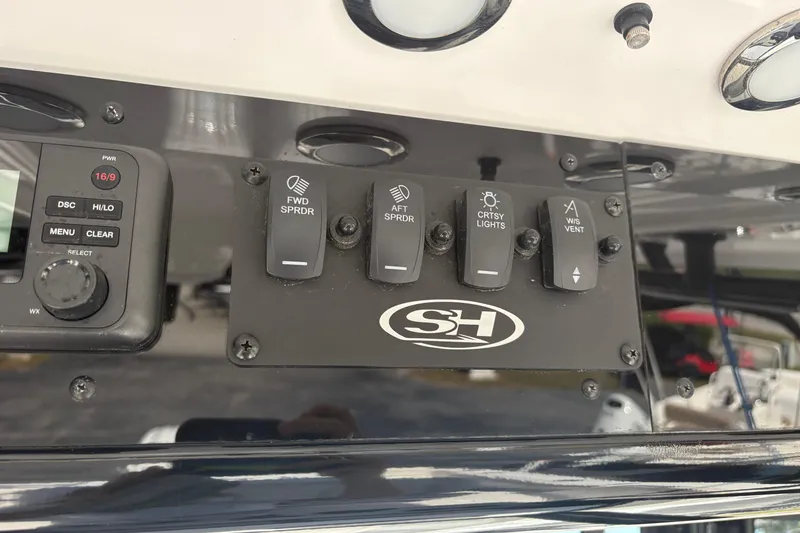 Slide: The Image of 2024 Sea Hunt Gamefish 27 Coffin Box dashboard with control switches and display panel. - 14