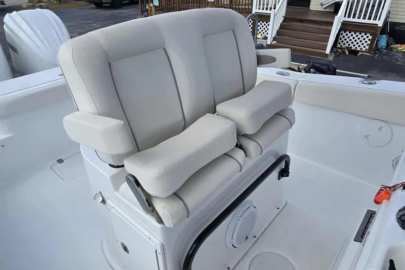 Slide: The Image of 2024 Sea Hunt Gamefish 27 Coffin Box boat seat, featuring plush white upholstery. - 21