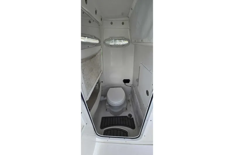 Slide: The Image of 2024 Sea Hunt Gamefish 27 Coffin Box boat interior with compact marine toilet. - 25