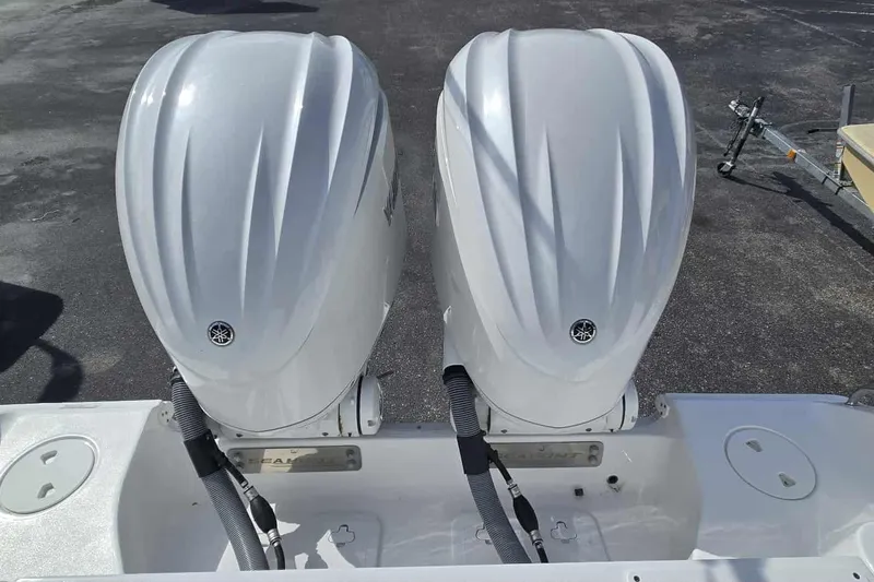 Slide: The Image of 2024 Sea Hunt Gamefish 27 Coffin Box with dual outboard engines, rear view. - 29