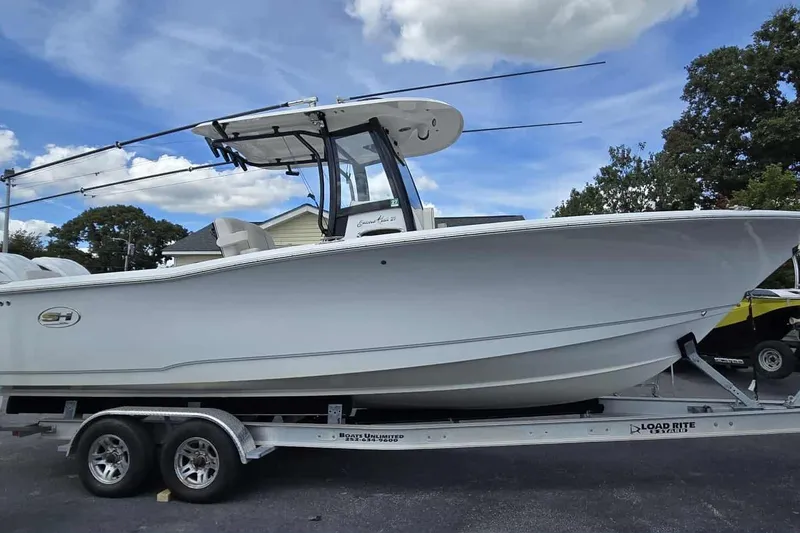 Slide: The Image of 2024 Sea Hunt Gamefish 27 Coffin Box boat on trailer under blue sky. - 3