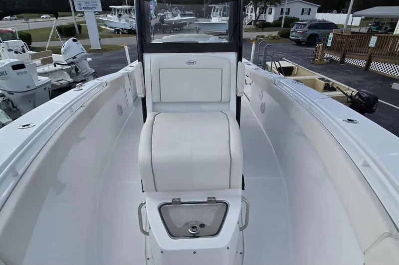 Slide: The Image of 2024 Sea Hunt Gamefish 27 Coffin Box boat interior with seating and storage. - 30