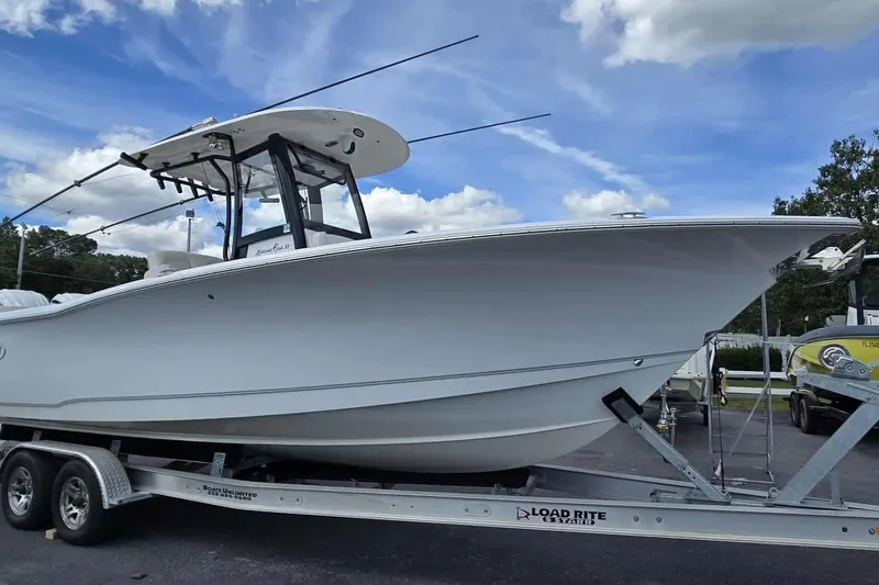 Slide: The Image of 2024 Sea Hunt Gamefish 27 Coffin Box boat on trailer under blue sky. - 5