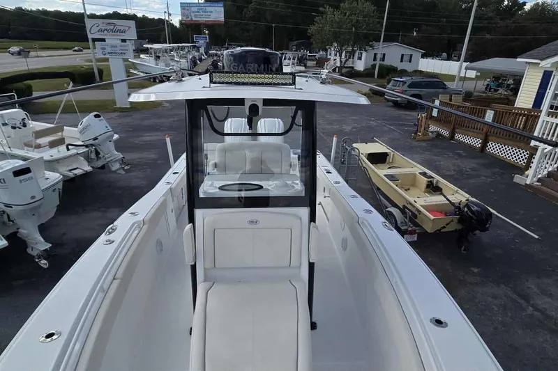Slide: The Image of 2024 Sea Hunt Gamefish 27 Coffin Box boat displayed at a dealership. - 6