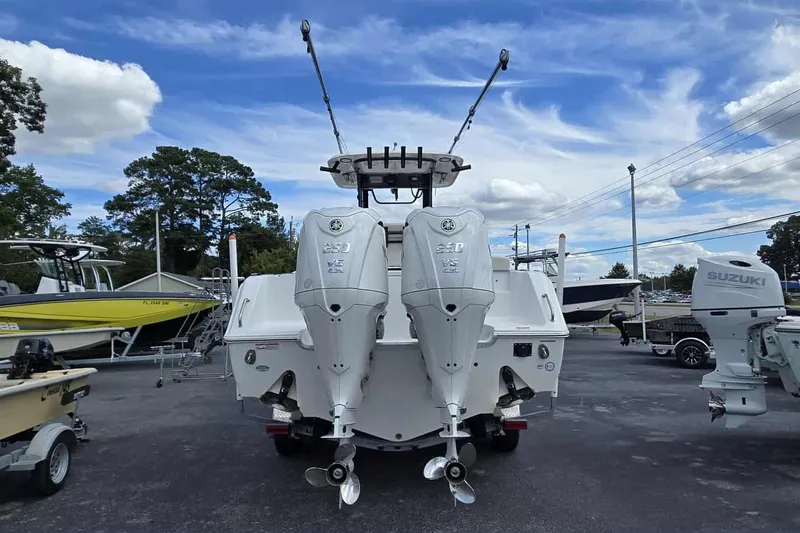 Slide: The Image of 2024 Sea Hunt Gamefish 27 Coffin Box with dual outboard motors, parked outdoors. - 7