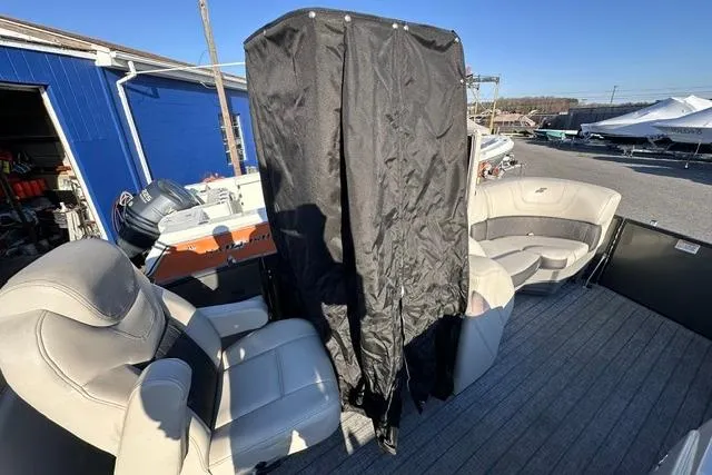 Slide: The Image of 2021 Starcraft SLS 1 boat interior with seating and covered area, docked outdoors. - 3