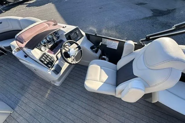 Slide: The Image of 2021 Starcraft SLS 1 boat interior with steering wheel and comfortable seating. - 8
