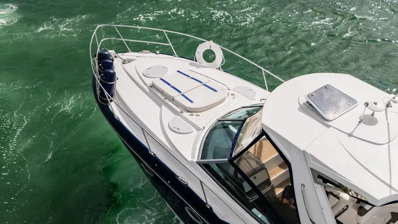 Slide: The Image of 2015 Monterey 335 Sport Yacht cruising on vibrant green water. - 13