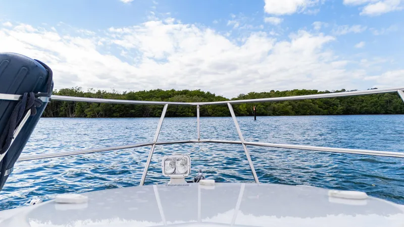 Slide: The Image of 2015 Monterey 335 Sport Yacht on calm blue water under a partly cloudy sky. - 16