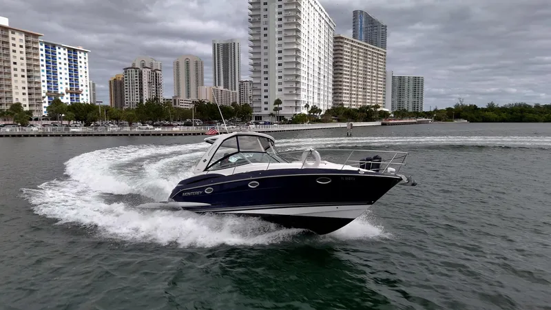 Slide: The Image of 2015 Monterey 335 Sport Yacht cruising in urban waterfront, surrounded by tall buildings. - 17