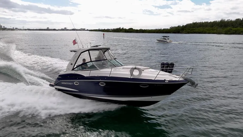Slide: The Image of 2015 Monterey 335 Sport Yacht cruising on open water, showcasing sleek design and performance. - 19
