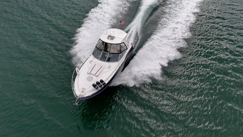 Slide: The Image of 2015 Monterey 335 Sport Yacht cruising on open water, aerial view. - 21