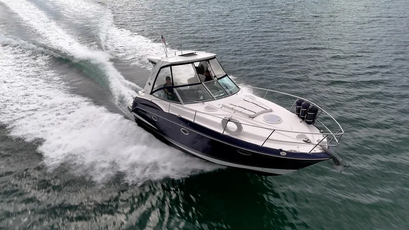 Slide: The Image of 2015 Monterey 335 Sport Yacht cruising on open water, creating a dynamic wake. - 22