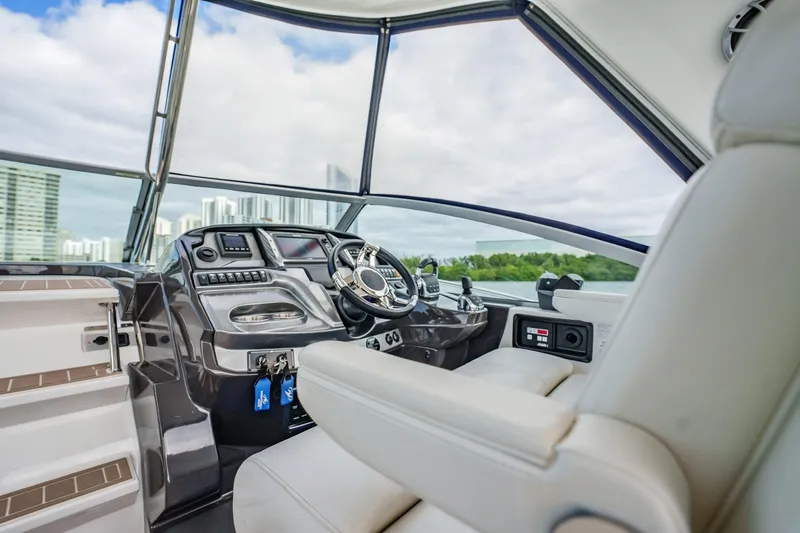 Slide: The Image of 2015 Monterey 335 Sport Yacht helm with modern controls and panoramic view. - 27