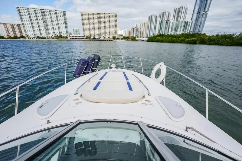 Slide: The Image of 2015 Monterey 335 Sport Yacht on water with city skyline in background. - 32