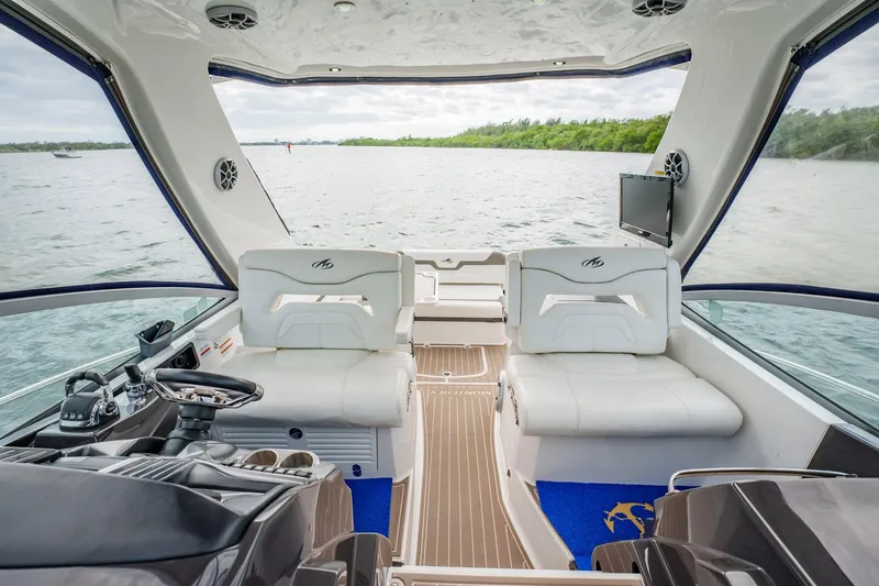 Slide: The Image of 2015 Monterey 335 Sport Yacht interior with luxurious seating and scenic water view. - 36