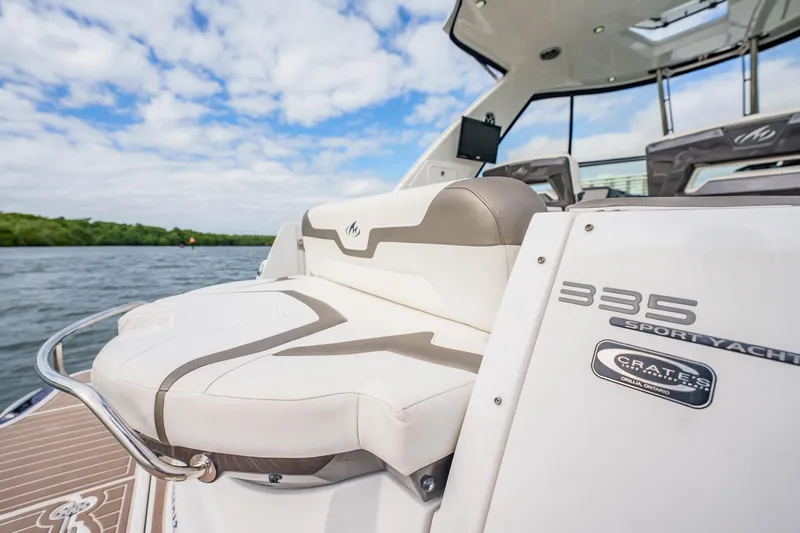 Slide: The Image of 2015 Monterey 335 Sport Yacht, luxurious seating, sleek design, on a scenic water backdrop. - 44