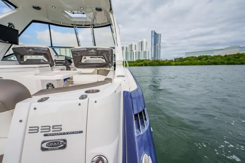 Slide: The Image of 2015 Monterey 335 Sport Yacht on water with city skyline in background. - 45