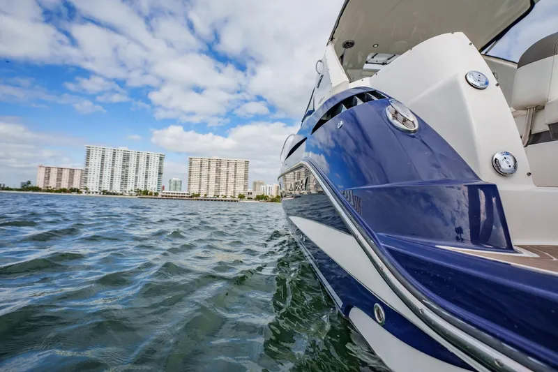 Slide: The Image of 2015 Monterey 335 Sport Yacht on water with city skyline in background. - 46