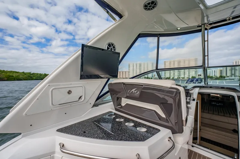 Slide: The Image of 2015 Monterey 335 Sport Yacht interior with TV, sleek design, and water view. - 47