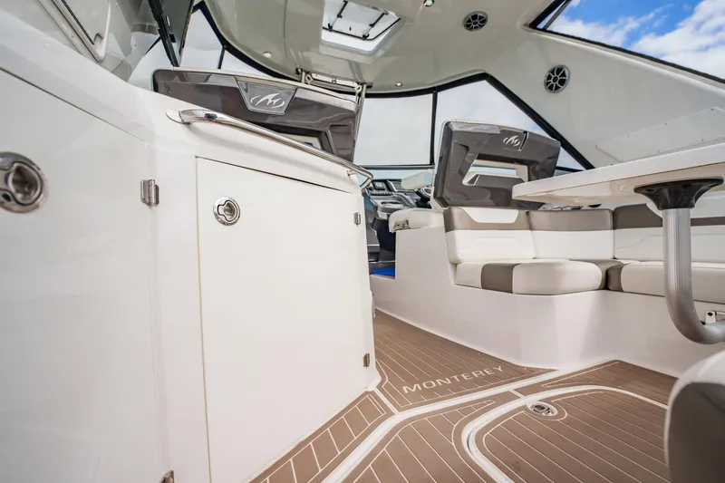 Slide: The Image of 2015 Monterey 335 Sport Yacht interior with modern seating and sleek design. - 49