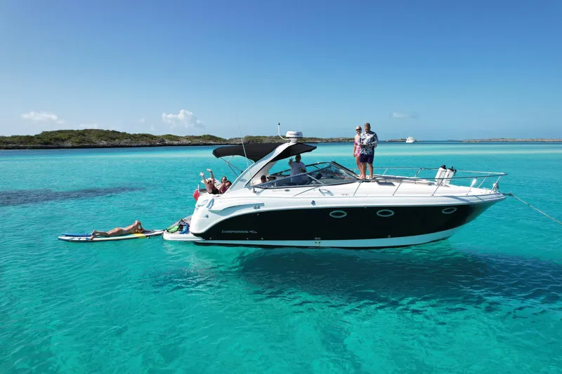 The Image of 2008 Chaparral 330 Signature boat in clear turquoise water with people enjoying the sun. - 0