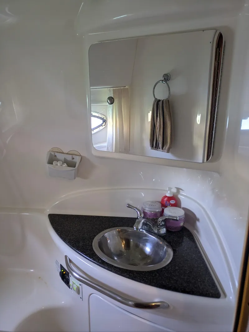 Slide: The Image of 2008 Chaparral 330 Signature bathroom sink with mirror and toiletries. - 5