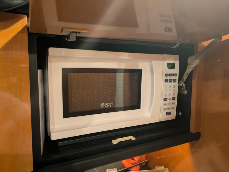 Slide: The Image of White microwave in the kitchen of a 2008 Chaparral 330 Signature boat. - 7