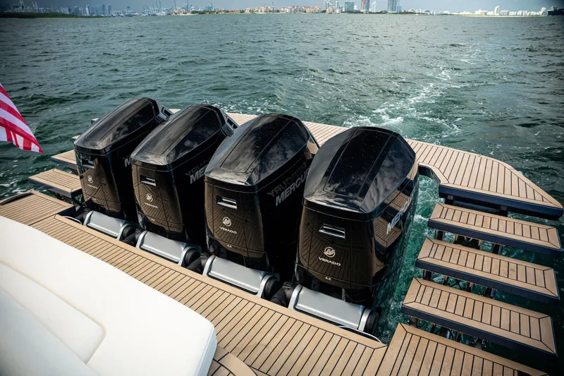 Slide: The Image of Four powerful outboard motors on a 2025 Dutch American DA 53 boat, cruising on open water. - 12