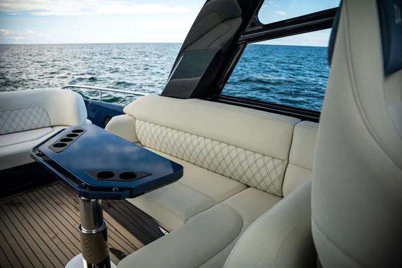Slide: The Image of Luxurious seating area on a 2025 Dutch American DA 53 yacht, overlooking the ocean. - 21