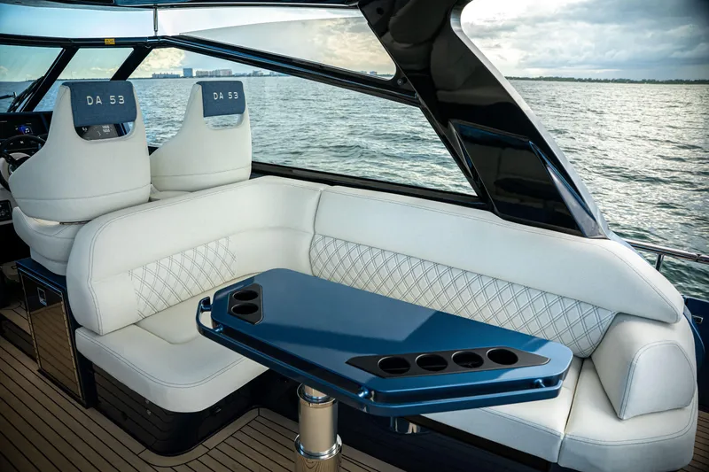 Slide: The Image of Luxurious 2025 Dutch American DA 53 yacht interior with white seating and sleek blue table. - 29