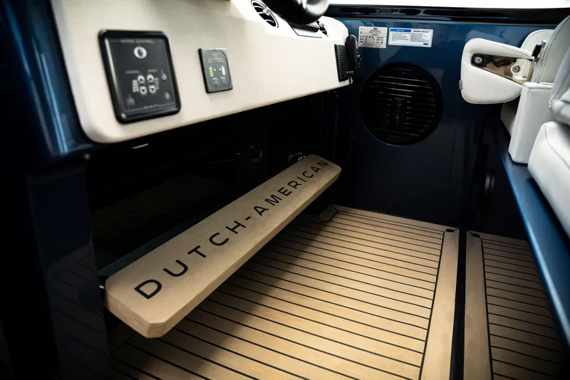 Slide: The Image of Interior of 2025 Dutch American DA 53 boat with branded step and control panel. - 49