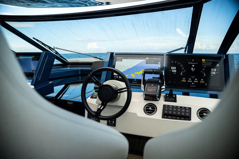 Slide: The Image of Modern yacht cockpit with advanced navigation displays, Dutch American DA 53, 2025 model. - 53