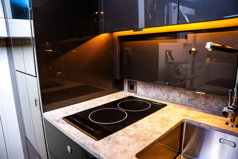 Slide: The Image of Modern kitchen with sleek design, featuring a Dutch American DA 53 cooktop, 2025 model. - 67