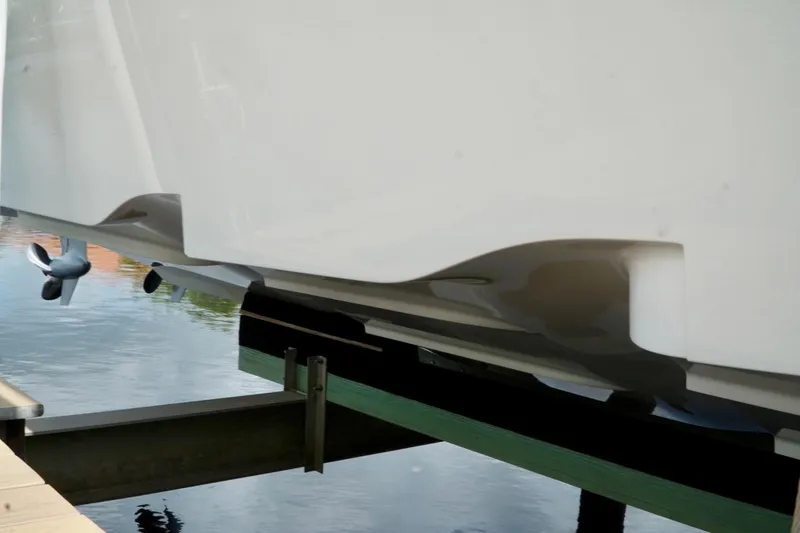 Slide: The Image of 2017 SeaVee 34Z boat hull and propeller on lift by water. - 100