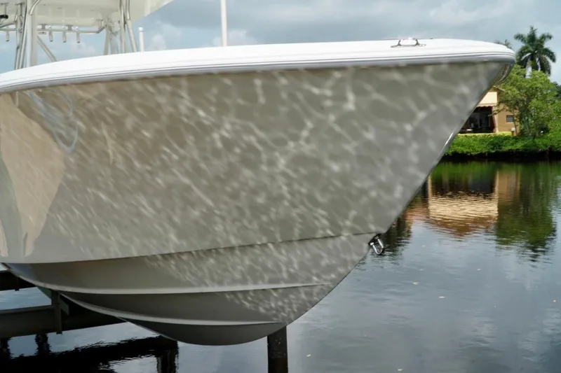 Slide: The Image of 2017 SeaVee 34Z boat reflecting water patterns, docked near lush greenery. - 101