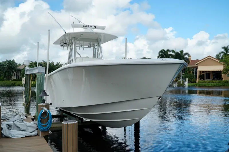 Slide: The Image of 2017 SeaVee 34Z boat docked on a serene waterfront with clear skies. - 104