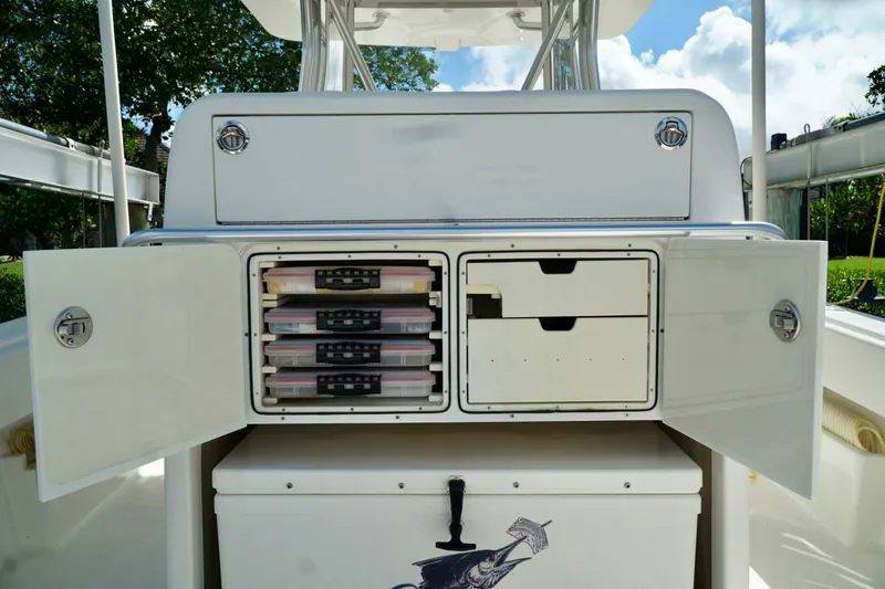 Slide: The Image of 2017 SeaVee 34Z boat storage compartments with open doors and organized tackle boxes. - 105