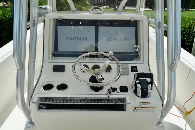 Slide: The Image of 2017 SeaVee 34Z boat console with Garmin displays and steering wheel. - 12