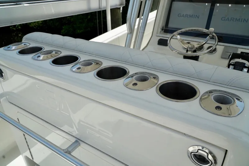 Slide: The Image of 2017 SeaVee 34Z boat console with cup holders and Garmin displays. - 13