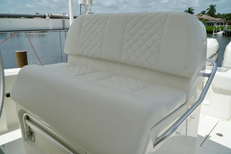 Slide: The Image of Luxurious white seating on 2017 SeaVee 34Z boat, featuring quilted upholstery and sleek design. - 14