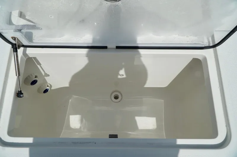 Slide: The Image of Open storage compartment on 2017 SeaVee 34Z boat, featuring a clean, white interior. - 23