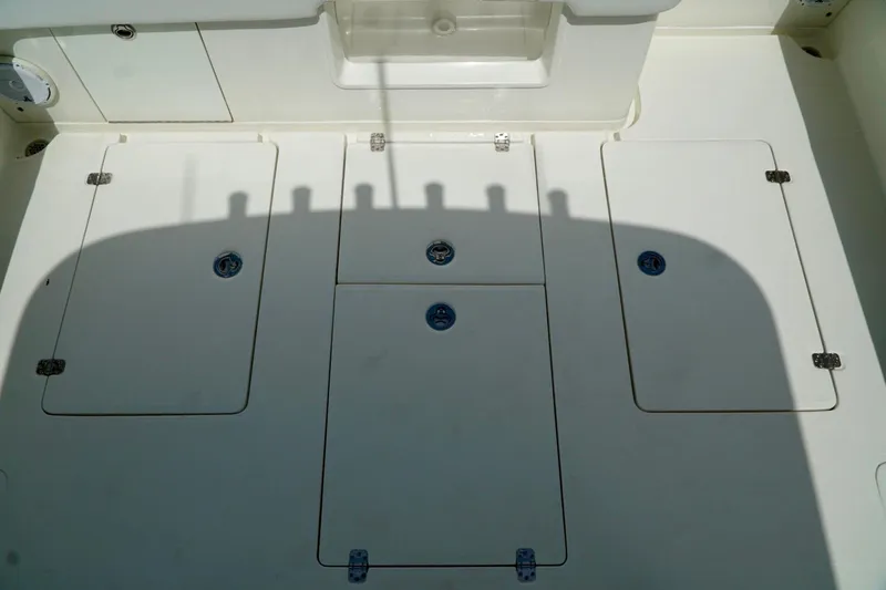 Slide: The Image of 2017 SeaVee 34Z boat deck with storage compartments and clean white surface. - 24