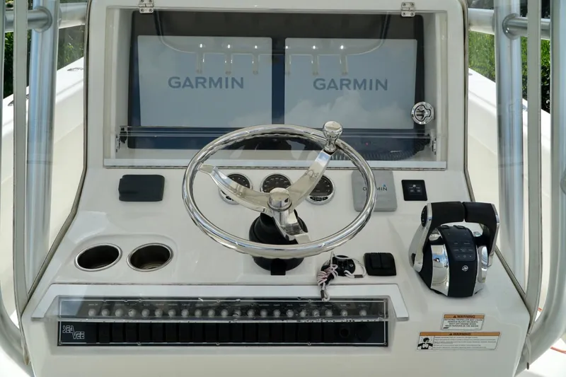 Slide: The Image of 2017 SeaVee 34Z boat helm with Garmin displays and steering wheel. - 25