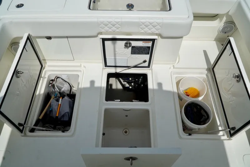 Slide: The Image of 2017 SeaVee 34Z boat storage compartments with fishing gear and buckets. - 29