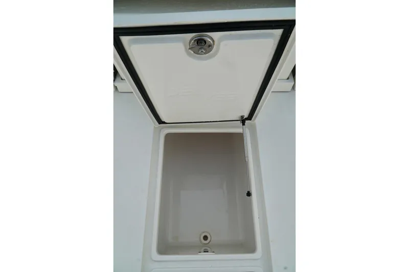 Slide: The Image of Open storage compartment on a 2017 SeaVee 34Z boat, featuring a hydraulic lift. - 31