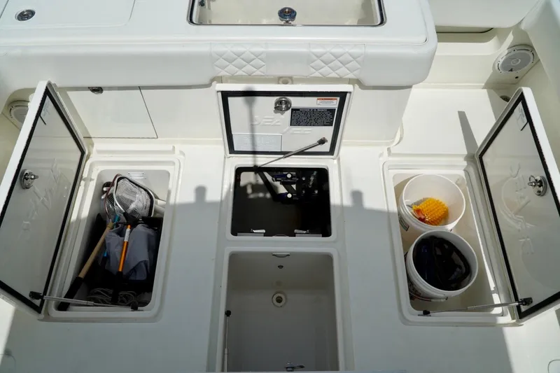 Slide: The Image of 2017 SeaVee 34Z boat storage compartments with fishing gear and buckets. - 32
